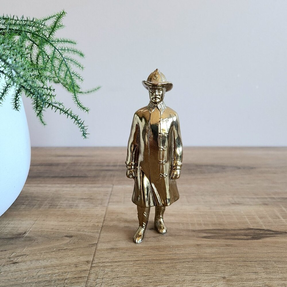 Vintage solid brass Fireman sculpture statue. Historic realistic figurine.